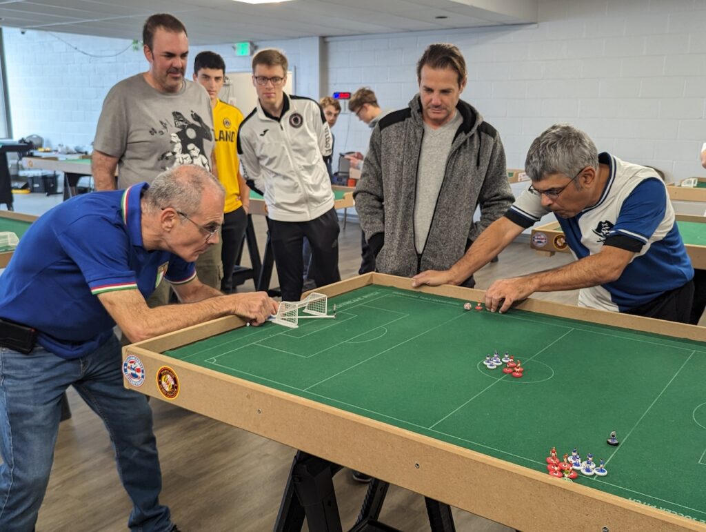 Two men playing table soccer